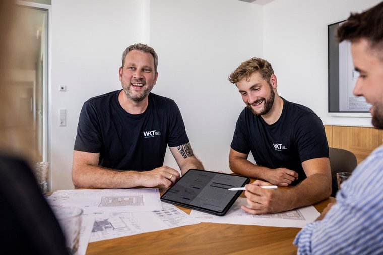Digitale Präsentation am Tablet Zwei Mitarbeiter der Firma WKT präsentieren Kunden einen Entwurf auf einem Tablet
